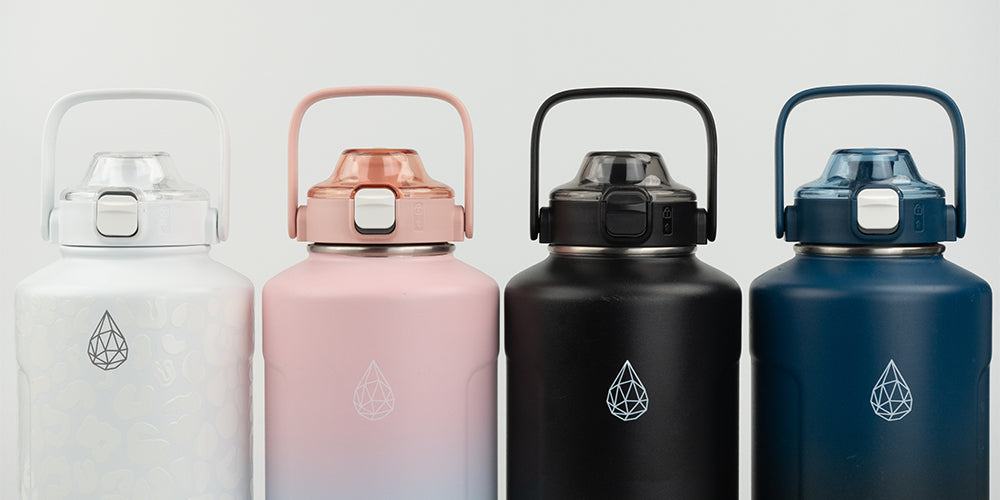 HydroH2O 64oz insulated water bottles in four colors: white, blush pink, matte black, and deep blue with leak-proof lids and wide handles